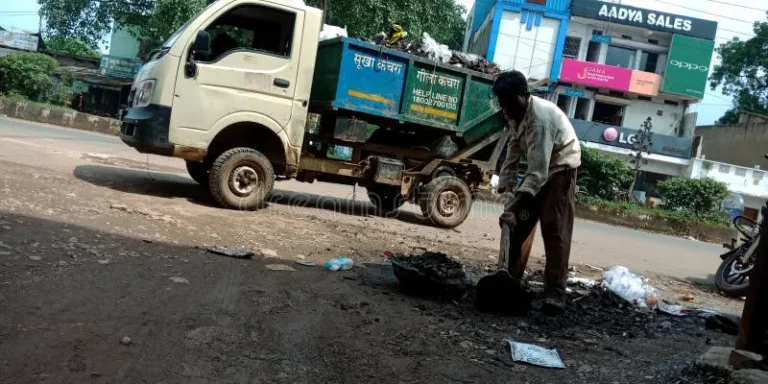 indian-munciple-corporation-worker-collecting-dirty-mud-sewage-road-side-india-oct-indian-munciple-corporation-worker-163894649