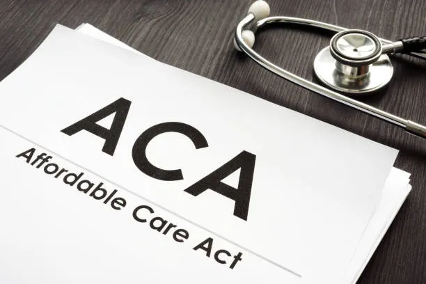 affordable-care-act-aca-and-stethoscope-on-a-wooden-desk